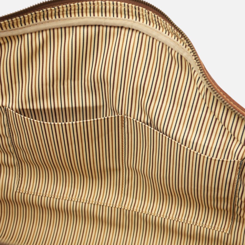 Interior of a striped fabric bag with beige, brown, and black vertical stripes, showing a zipper at the top and two inner pockets.