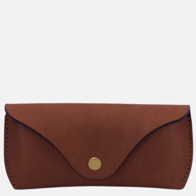 Brown leather wallet with a rounded flap and brass snap closure on a plain background to the left of the image.