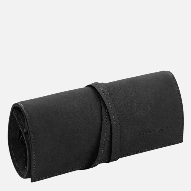 Black leather roll-up wallet with a wrap strap, embossed 'Tuscany Leather' on the side, lying diagonally on a light background.