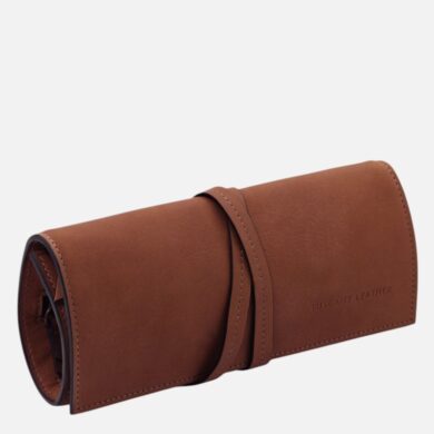 Brown leather glasses case with a wrap strap, branded Tuscany Leather, on a light background.