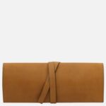 Tan leather wallet with a wraparound strap closure and stitched edges, branding visible on the lower right (Tuscany Leather).