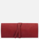 Red leather wallet with a wraparound strap, brand stamp 'TUSCANY LEATHER' on the lower right.