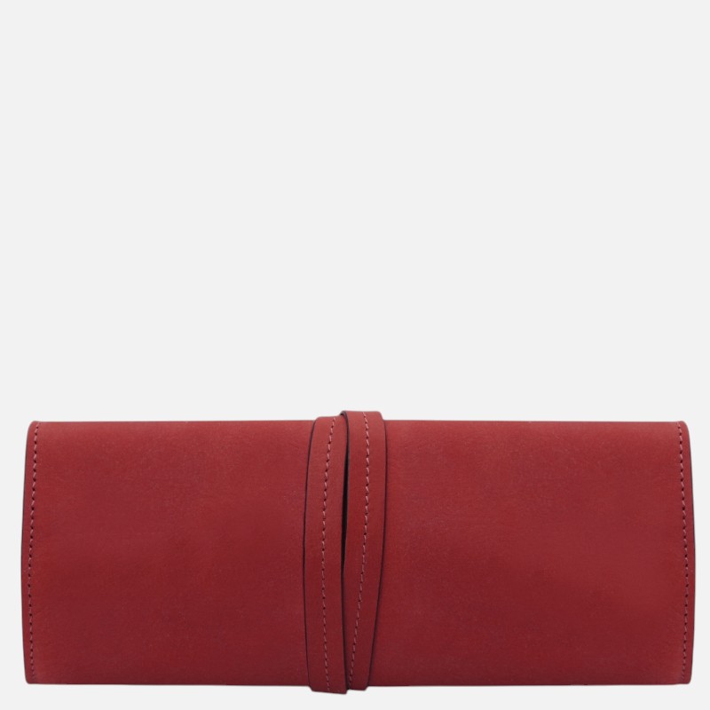 Red leather clutch wallet with a vertical wraparound strap, laid flat to show clean, minimalist design.