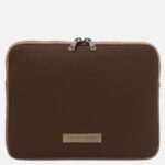 Brown leather zippered square laptop sleeve with light tan trim and a metal label reading 'Tuscany Leather' on the front.