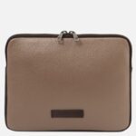 Tan pebble-grain leather zippered pouch with dark brown trim and a double zipper, featuring a Tuscany Leather brand patch.