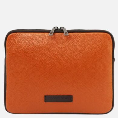 Orange textured leather zippered bag with black edging and a small Tuscany Leather label on the front.