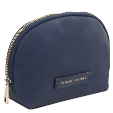 Inside a red-lined zippered bag showing a navy leather tag with a copper plate reading 'Tuscany Leather' and 'Handmade in Italy'